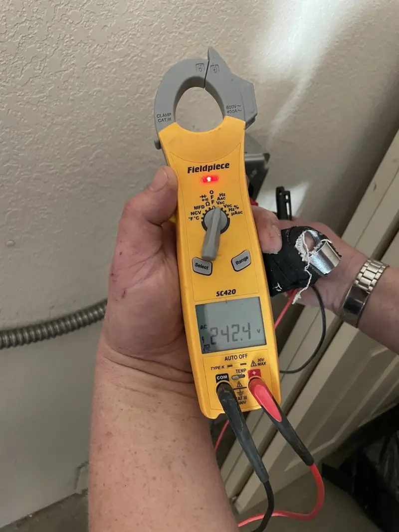 Voltage testing with clamp meter during Recessed Lighting Installation in Fox Chapel